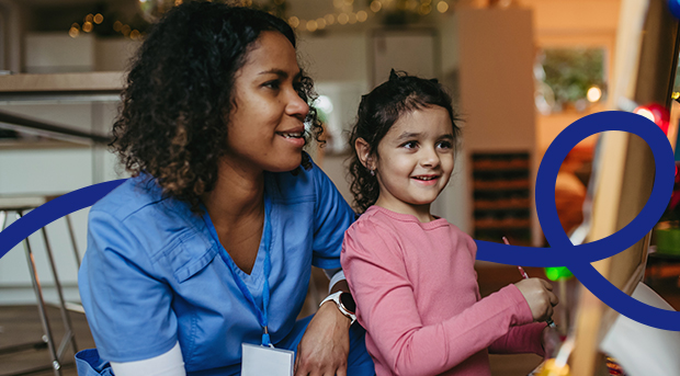 A mother and her daughter sitting at a table in their kitchen. 
