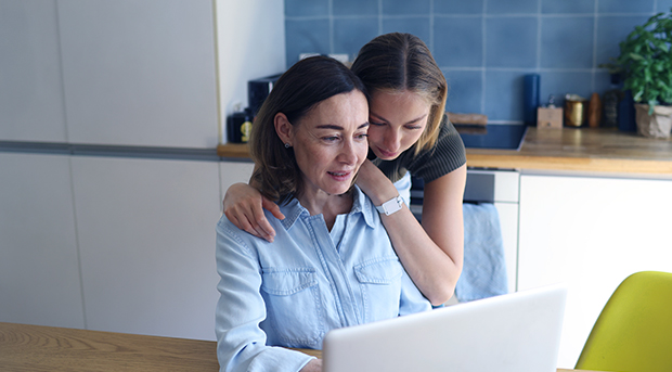 Mother and daughter near laptop