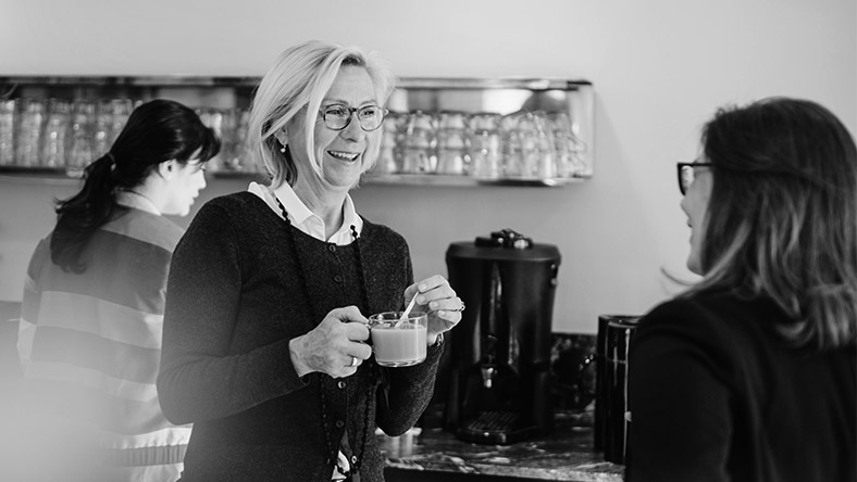 A barista has a friendly chat with a customer.