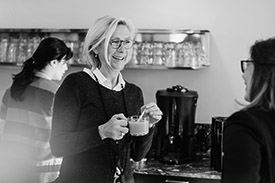 A barista has a friendly chat with a customer.