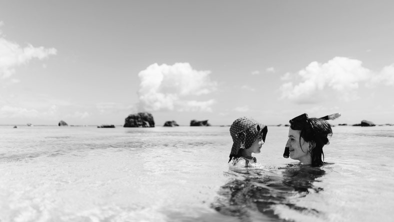 A woman and child snorkelling because she booked a holiday using a personal loan to pay for it.