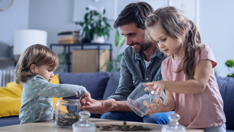 Dad with kids playing around a table