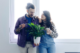 Couple holding a plant