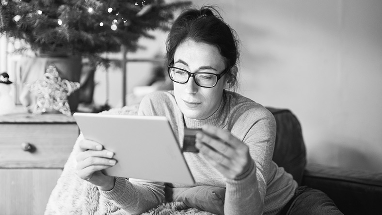 Woman on tablet online shopping with credit card