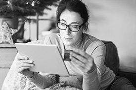 Woman on tablet online shopping with credit card