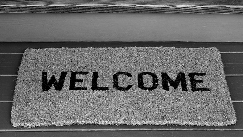 A doormat to a home owner's property reading 'Welcome'.