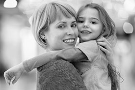 Feel Good Wealth Responsible Products with a young woman holding a child, both looking at the camera.